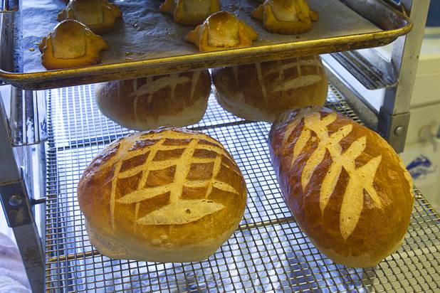 Fresh bread cools on racks at Chef Flemmings Bake Shop, a European-style bakery, on Water Street in downtown Henderson Thursday, Dec. 20, 2012.