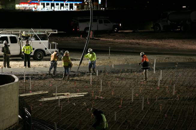 Construction workers manage the concrete pour as it's laid onto the site of the 17,000-square-foot wave pool at Las Vegas' newest attraction Wet 'n' Wild, a 41-acre water park expected to open in Spring of 2013, Thursday, Dec. 20, 2012.