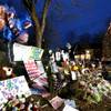 A Christmas tree, right, is surrounded by makeshift memorials that are multiplying by the day in the Sandy Hook village of Newtown, Conn., the site of a shooting massacre last week, Thursday, Dec. 20, 2012. 