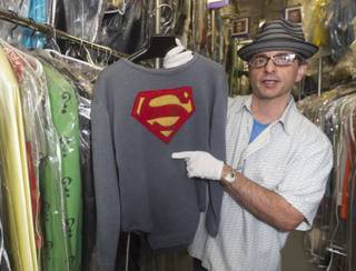 In this Friday, Nov. 30, 2012 photo, James Comisar holds the costume George Reeves wore in the 1950s TV show 