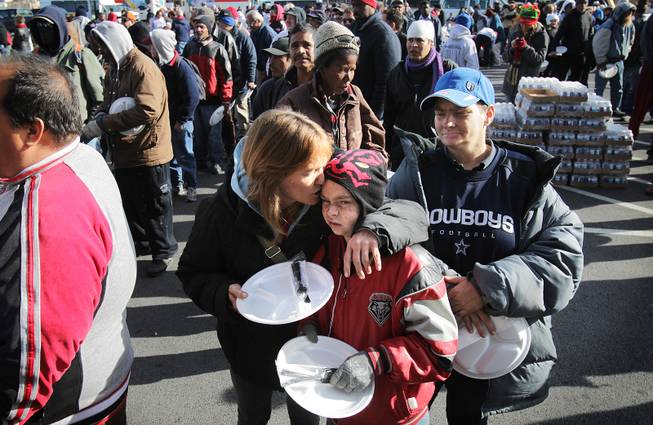 Melissa Dile, from left, gives her nephew Eugene Adams, 13, ...