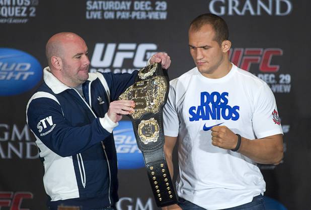 UFC president Dana White drapes the heavyweight championship belt on Junior Dos Santos of Brazil during a news conference at the MGM Grand Thursday, Dec. 27, 2012. Dos Santos will defend the title against Cain Velasquez of San Jose, Calif. during UFC155 at the MGM Grand Garden Arena Saturday .