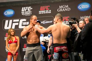 Junior dos Santos and Cain Velasquez face off during the weigh-in for UFC 155, Friday, Dec. 28, 2012.