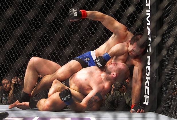 Yushin Okami, top, of Japan takes an elbow from Alan Belcher of Biloxi, Miss. during a middleweight bout UFC155 at the MGM Grand Garden Arena Saturday, Dec. 29, 2012. 
