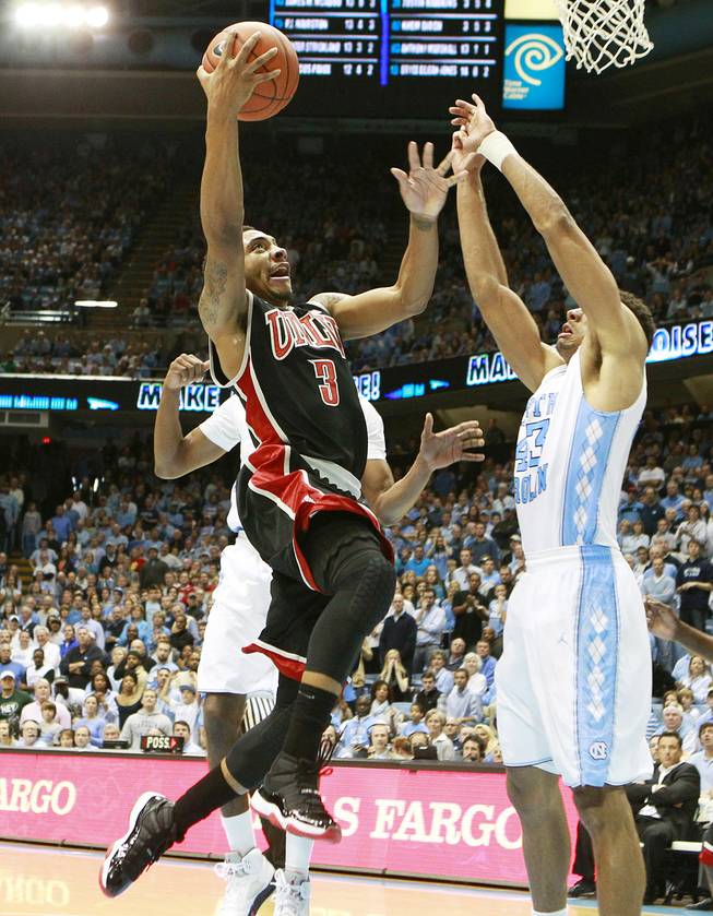 UNLV guard Anthony Marshall shoots over North Carolina forward James Michael McAdoo during their game Saturday, Dec. 29, 2012 at the Dean Smith Center in Chapel Hill, N.C. North Carolina won the game 79-73.
