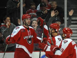 Andrew Sarauer (25) celebrates with teammates after scoring a third period goal against the Idaho Steelheads on Sunday afternoon at the Orleans Arena.