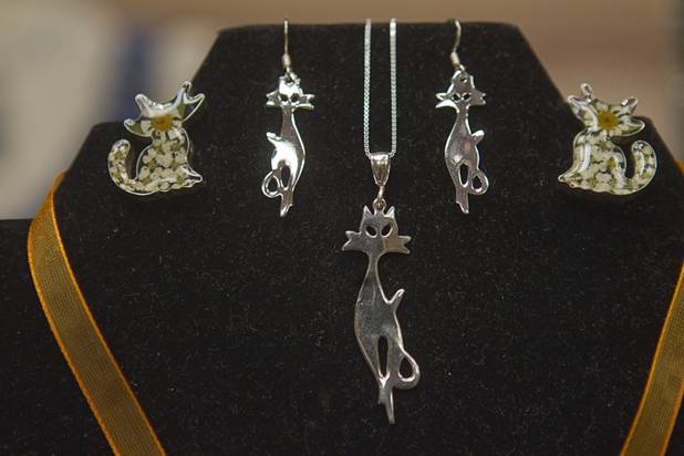 Cat-themed jewelry is displayed at the Flow Design booth during the annual Cat A Lina Cat Club Championship Cat Show at the Riviera Sunday, Dec. 30, 2012.