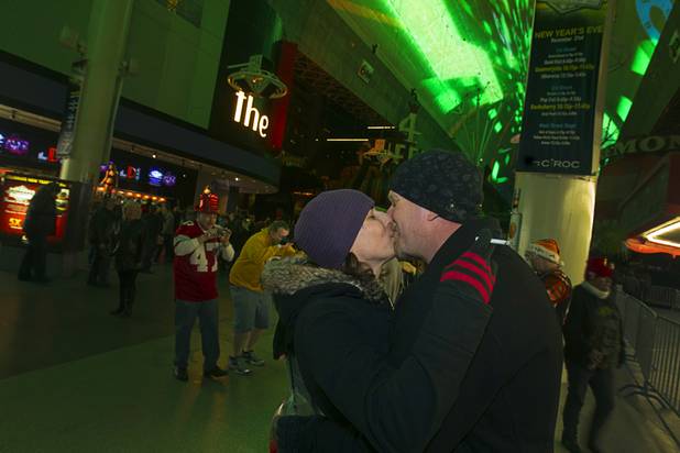 Melissa Ochs and Mike Campbell kiss during the New Years Eve party at the Fremont Street Experience Monday, Dec. 31, 2012.