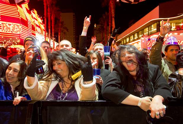 Jeanette Salaiz, left, and Tracy Clark listen to the band Pop Evil during the New Years Eve party at the Fremont Street Experience Monday, Dec. 31, 2012.