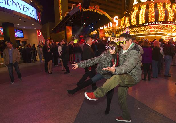 A couple pose for a photo during the New Years Eve party at the Fremont Street Experience Monday, Dec. 31, 2012.