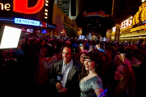 Channel 3-KSNV meteorologist Kevin Janison prepares to interview Claire Sinclair, 2011 Playboy Playmate of the Year, during the New Year's Eve party at Fremont Street Experience on Monday, Dec. 31, 2012.