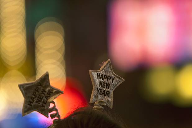 A woman wears a decorative headband during the New Years Eve party at the Fremont Street Experience Monday, Dec. 31, 2012.