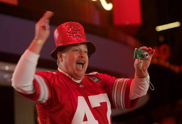 Don Markley gets people together for a video as they sing Don McLean's "American Pie" during the New Years Eve party at the Fremont Street Experience Monday, Dec. 31, 2012.