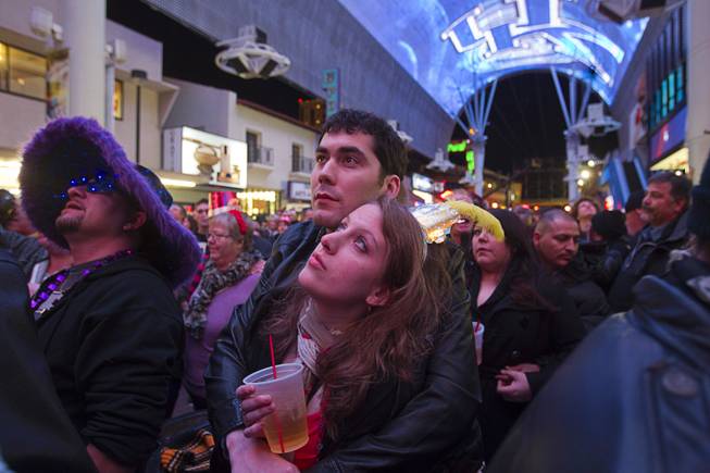 Troy Nuccio and Danielle Weber of Detroit wait for fireworks just before midnight during the New Years Eve party at the Fremont Street Experience Monday, Dec. 31, 2012.