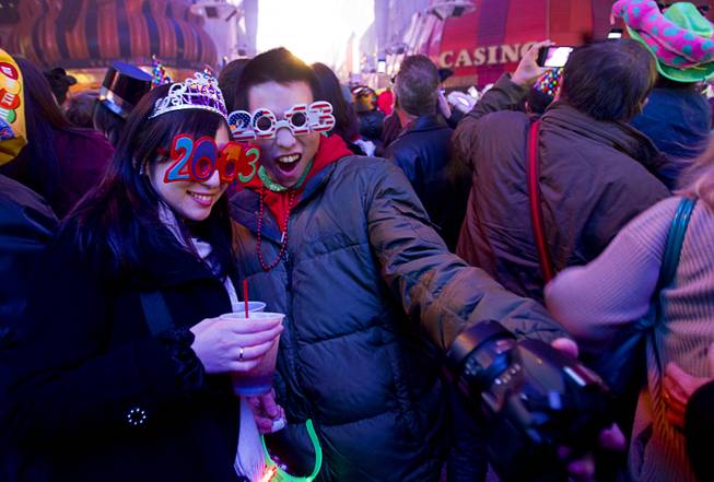 Saya Kamiya and Toshi Wada of Japan take a self-portrait just after midnight during the New Years Eve party at the Fremont Street Experience Tuesday, Jan. 1, 2013.