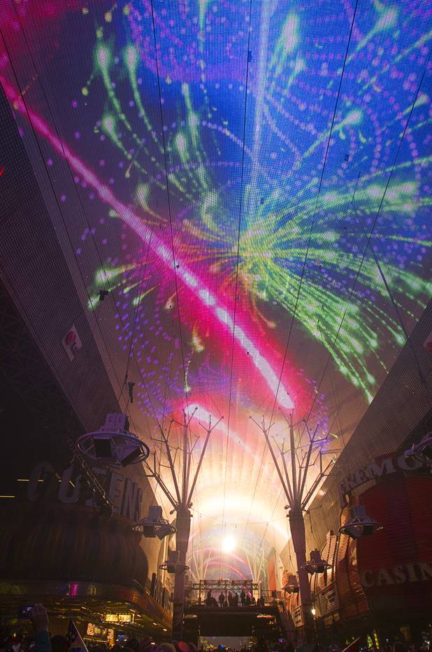 On-screen fireworks and pyrotechnics explode just after midnight during the New Years Eve party at the Fremont Street Experience Tuesday, Jan. 1, 2013.