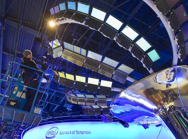 Rigger Matt Gerbracht looks over a display of Ultrabooks powered with Intel processors as workers prepare for the International CES show at the Las Vegas Convention Center in Las Vegas, Nevada January 4, 2013. The annual CES electronics technology trade show is expected to cover 1.85 million square feet of exhibition space and attract 150,000 attendees. The show begins January 8.