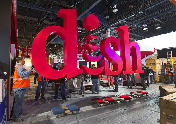 Workers build a booth for Dish, a satellite TV provider, as they prepare for the International CES show at the Las Vegas Convention Center in Las Vegas, Nevada January 4, 2013. The annual CES electronics technology trade show is expected to cover 1.85 million square feet of exhibition space and attract 150,000 attendees. The show begins January 8.
