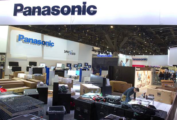 Workers prepare the Panasonic booth for the International Consumer Electronics Show at the Las Vegas Convention Center on Friday, Jan. 4, 2013. The annual electronics and technology trade show is expected to cover 1.85 million square feet of exhibition space and attract 150,000 attendees.
