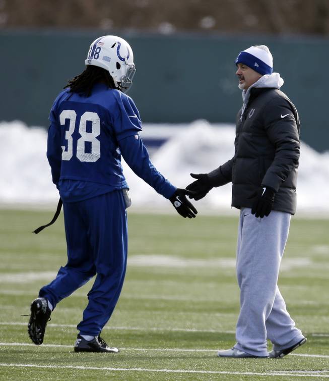 Indianapolis Colts head coach Chuck Pagano, right, encourages Sergio Brown during pratice at the Colts complex Wednesday, Jan. 2, 2013, in Indianapolis. The Colts will play the Baltimore Ravens in a AFC Wild Card playoff game Sunday.