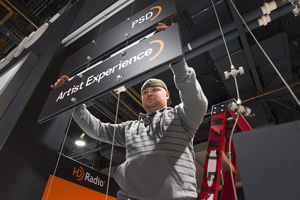 Juan Galdamez sets up a HD Radio booth for the International CES at the Las Vegas Convention Center in Las Vegas, Nevada January 5, 2013. The annual CES electronics technology trade show is expected to cover 1.85 million square feet of exhibition space and attract 150,000 attendees. The show begins January 8.