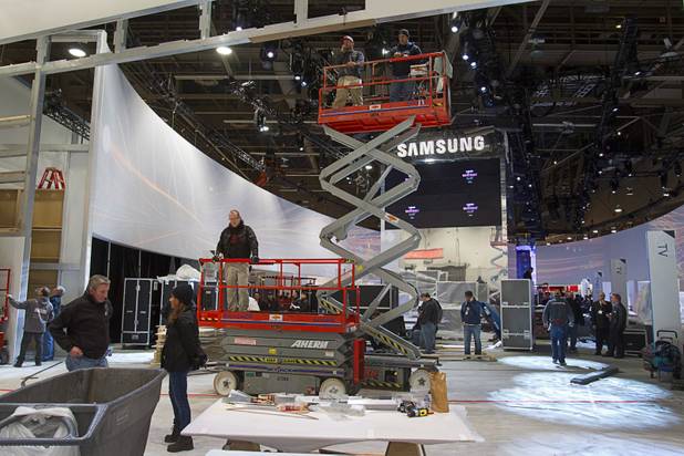 Workers prepare the Samsung booth for the International CES at the Las Vegas Convention Center in Las Vegas, Nevada January 5, 2013. The annual CES electronics technology trade show is expected to cover 1.85 million square feet of exhibition space and attract 150,000 attendees. The show begins January 8.