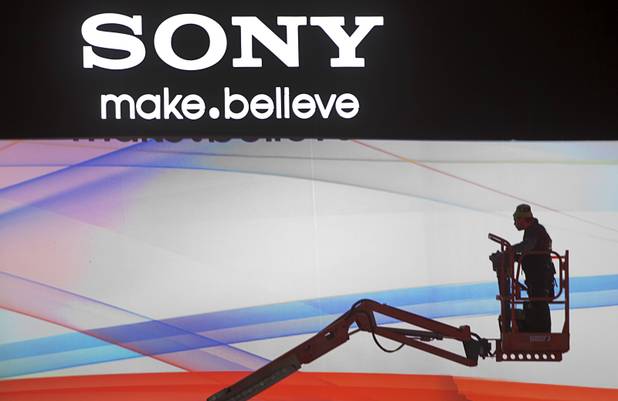A man rides a lift in the Sony booth as workers prepare for the International CES at the Las Vegas Convention Center in Las Vegas, Nevada January 5, 2013. The annual CES electronics technology trade show is expected to cover 1.85 million square feet of exhibition space and attract 150,000 attendees. The show begins January 8.