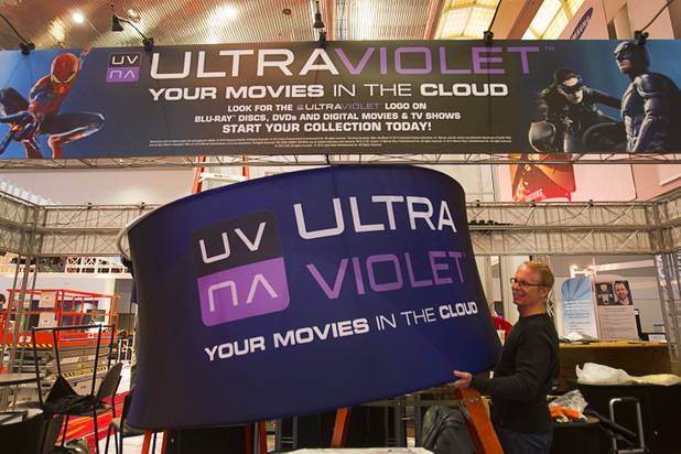 Workers prepare an UltraViolet booth in the lobby of the Las Vegas Convention Center for the International CES in Las Vegas, Nevada January 5, 2013. UltraViolet is a cloud-based licensing system that allows users to stream videos to multiple devices.
