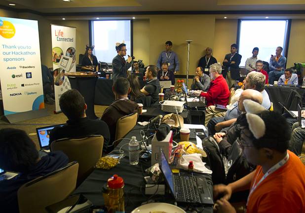 Alex Donn, back left, developer evangelist with the AT&T Developer Program, speaks to mobile App developers during a 26-hour innovation Hackathon at the Palms Saturday, January 5, 2013. More than 200 innovators competed for $125,000 in cash and prizes as they tried to develop the mobile apps of tomorrow. The event is a prelude to the annual AT&T Developer Summit .