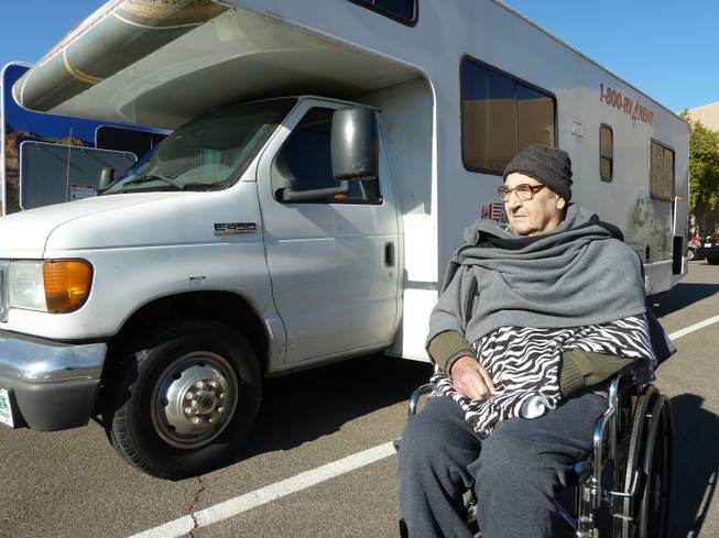 John Glionna sits outside RV rental office in Mesa, Az. with the husk of the old mobile home.