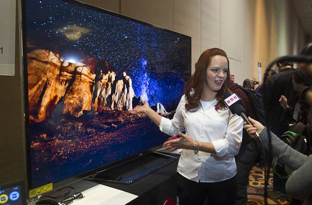 Nitza Martinez shows off an 84-inch Ultra HD LED television by LG Electronics at the opening press event of the 2013 International CES at the Mandalay Bay Convention Center Sunday, January 6, 2013. The retail price for the television is $19,999.99.