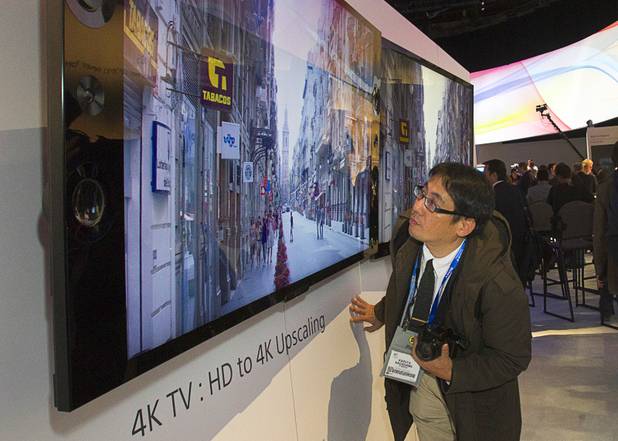 A reporter looks at a Sony X-Reality PRO 4K Ultra HD television during a Sony news conference at the 2013 International CES in the Las Vegas Convention Center Monday, January 7, 2013.