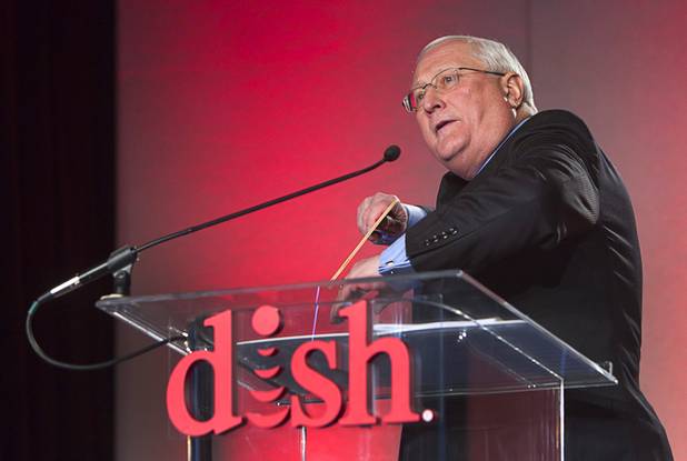 Dish CEO Joe Clayton pretends to throw a boomerang during a Dish news conference at the 2013 International CES in the Mandalay Bay Convention Center Monday, January 7, 2013. Dish announced improvements to its Hopper DVR system including a built-in Slingbox that will allow consumers to view content on mobile devices without any extra cost.
