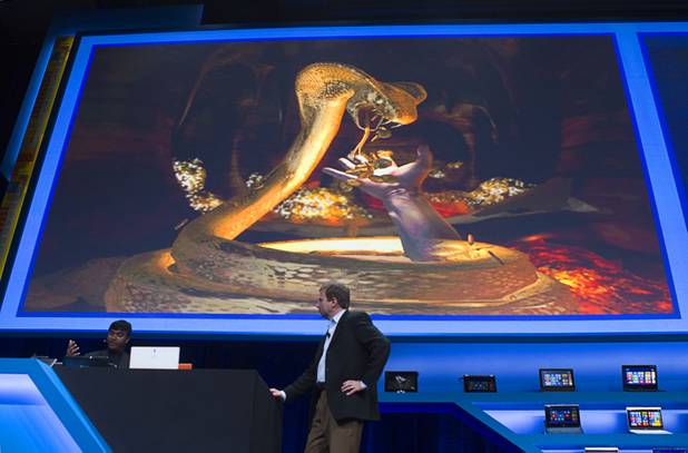 Achin Bhownik (L) demonstrates a computer game with conceptual computing features to Kirk Skaugen, vice president of PC client group for Intel, during an Intel press conference during the 2013 International CES in the Mandalay Bay Convention Center Monday, January 7, 2013. Intel announced improvements to its processors including one with "all day" battery life. Intel also announced the availability of live and on-demand pay TV content to Intel devices.