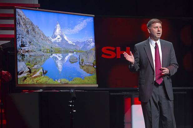 Jim Sandusky, vice president of strategic product marketing for Sharp Electronics, shows off an Ultra HD television at a Sharp press conference during the 2013 International CES in the Mandalay Bay Convention Center Monday, January 7, 2013. Sharp introduced new television technology and devices made with IGZO technology (Indium gallium zinc oxide) which promises ultra-high screen resolution with very low power usage. The TV is expected to ship in the second half of 2013.