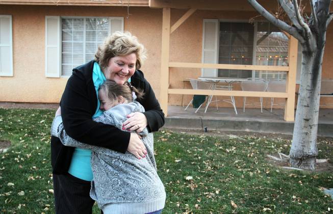 CEO Kelly DeGuzman, top, hugs resident Lisa Marie Potter at New Vista Ranch in Las Vegas on Monday, January 7, 2013.