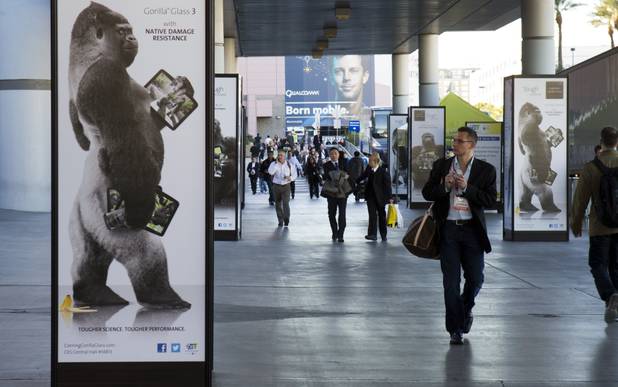 A man walks by an advertisement for Corning Gorilla Glass 3 outside the Las Vegas Convention Center on the first day of the 2013 International CES in the Las Vegas Convention Center Tuesday, Jan. 8, 2013. STEVE MARCUS