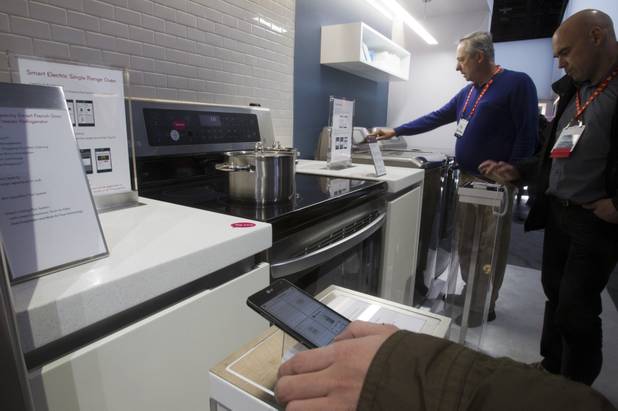 Show-goers look smart kitchen appliances in the LG Electronics booth during the first day of the 2013 International CES in the Las Vegas Convention Center Tuesday, Jan. 8, 2013. STEVE MARCUS