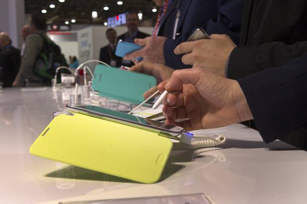 A show-goer tries out the Samsung Galaxy Note II phone/tablet during the first day of the 2013 International CES in the Las Vegas Convention Center Tuesday, Jan. 8, 2013. STEVE MARCUS
