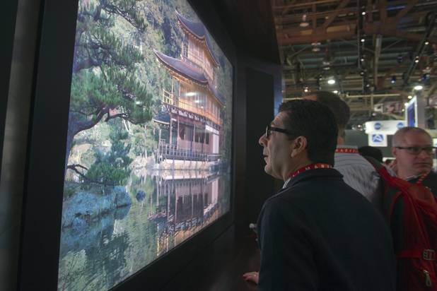 William Minna gets a close look at an Sharp 85-inch 8K prototype television during the first day of the 2013 International CES in the Las Vegas Convention Center Tuesday, Jan. 8, 2013. The television has 16 times the resolution of 1080p. STEVE MARCUS