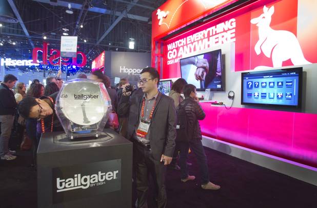 Show-goers look over a Tailgater satellite dish at the Dish Network booth during the first day of the 2013 International CES in the Las Vegas Convention Center Tuesday, Jan. 8, 2013. STEVE MARCUS