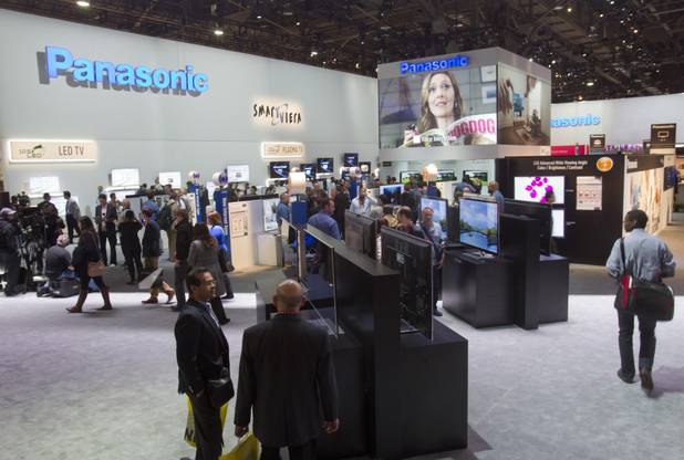 Show-goers look over televisions at the Panasonic booth during the first day of the 2013 International CES in the Las Vegas Convention Center Tuesday, Jan. 8, 2013. STEVE MARCUS