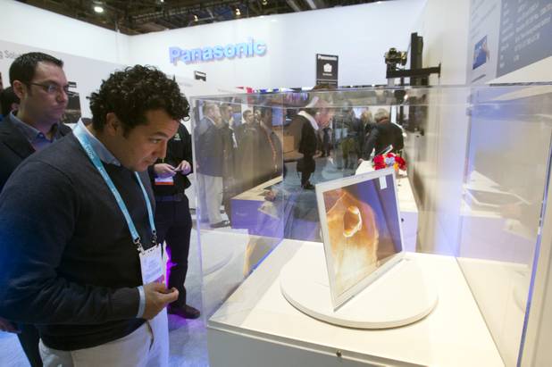A man looks over a Panasonic 4K tablet featuring a 20-inch screen during the first day of the 2013 International CES in the Las Vegas Convention Center Tuesday, Jan. 8, 2013. STEVE MARCUS