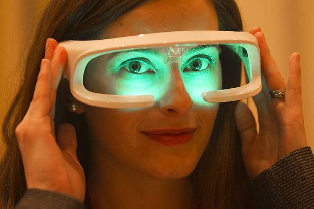 Claire Hobean, operations manager for Re-Time, models the Re-Timer during the 2013 International CES Wednesday, January 9, 2013. The product helps reset your body clock by shining a green 500 nanometer light over your eyes. The product is beneficial for frequent fliers and shift workers, she said. The Australian company just released the ReTmer in Australia (AUD 273.90) and will launch in the U.S. this week.