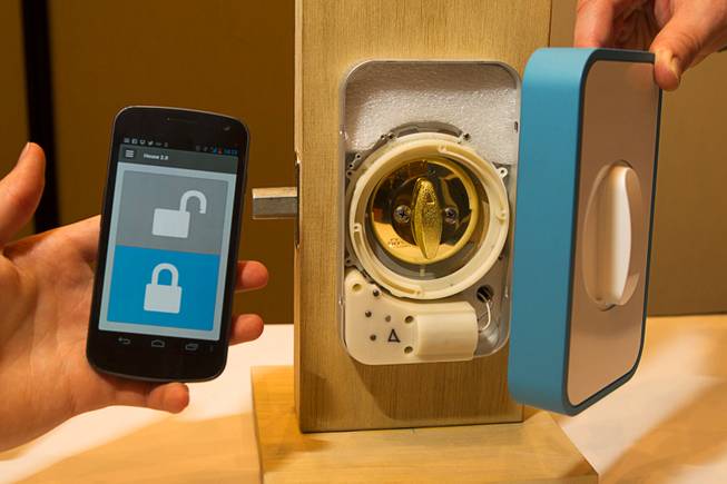 The Lockitron by Apigy Inc. is displayed during the 2013 International CES Wednesday, January 9, 2013. The Lockitron retrofits over a deadbolt door lock and the door can be locked and unlocked with a smartphone. The $179.00 system will be shipping in March, said co-founder Cameron Robertson.