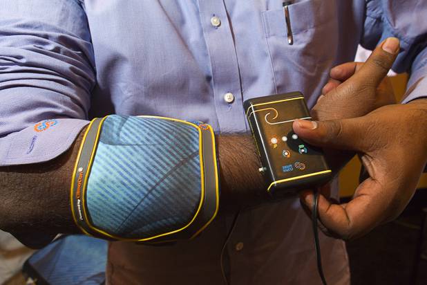 Kranthi Vistakula models a ClimaWare relief system elbow wrap by Dharma Innovations during the 2013 International CES Wednesday, January 9, 2013. The system uses technology developed at Massachusetts Institute of Technology and can cool wraps to 38 degrees Fahrenheit or heat them to 140 degrees Fahrenheit in seconds, Vistakula said.