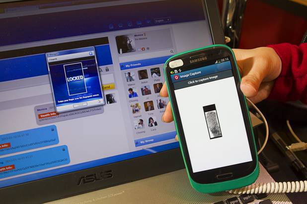 A PrivacQ cell case with built-in finger print scanner is displayed during the 2013 International CES Wednesday, January 9, 2013. The Hong Kong-based company, a subsidiary of World Wide Touch Technology, also showed FingerQ, a web-based platform that provides secure social networking capability.