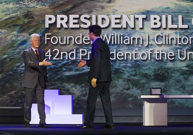 Former President Bill Clinton (L) is welcomed onstage by Stephen Woo, president of Device Solutions Business for Samsung Electronics, during a Samsung keynote address at the 2013 International CES Wednesday January 9, 2013.