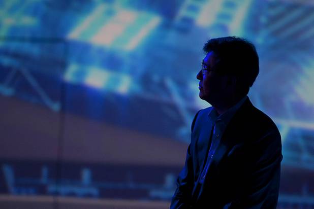 Stephen Woo, president of Device Solutions Business for Samsung Electronics, watches a video presentation during a keynote address at the 2013 International CES on Wednesday, Jan. 9, 2013. Samsung introduced a new faster processor and prototype devices with flexible OLED screens.