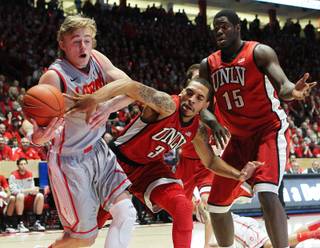 UNLV guard Anthony Marshall knocks the ball out of the hands of New Mexico guard Hugh Greenwood during their game Wednesday, Jan. 9, 2013, at The Pit in Albuquerque.